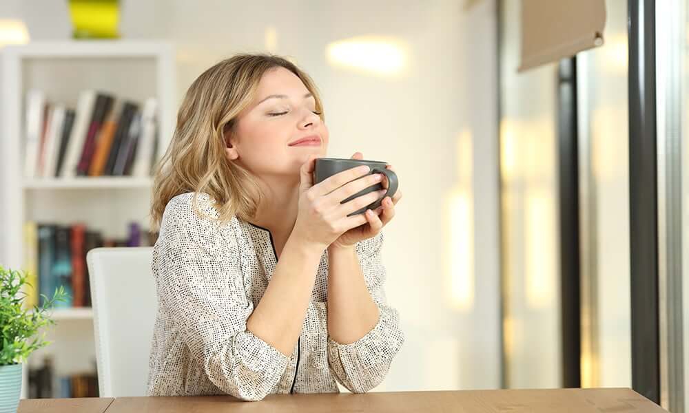 lady holding mug at table
