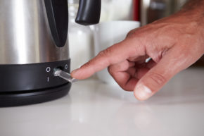 a hand clicking a kettle on