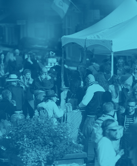 Blue gradient over image of crowd at a live event