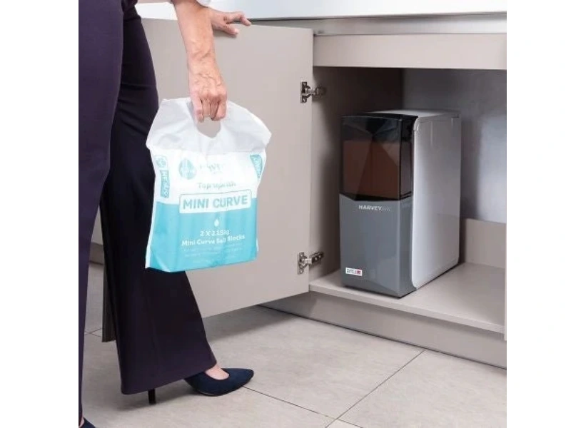 A woman refilling water softener salt.